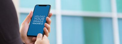 iPhone 11 Pro Mockup Being Held by a Businessman Outside the Office