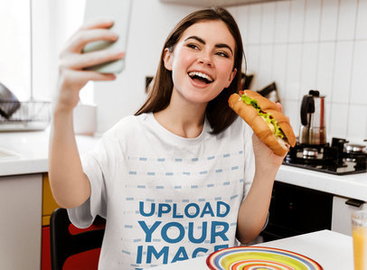 T-Shirt Mockup of a Woman Taking a Selfie While Eating a Sandwich