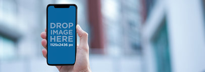 iPhone 11 Pro Mockup Being Held by a Guy at the Street