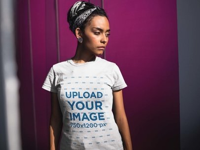 Woman Wearing a T-Shirt Mockup While Near a Pink Room