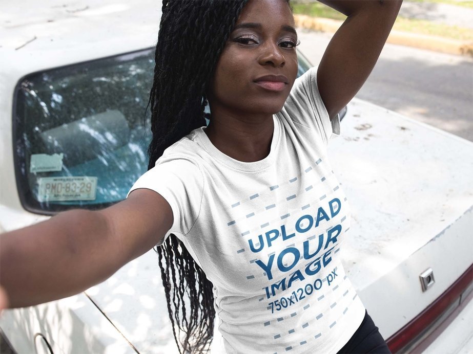 Selfie of a Woman with Locs Wearing a Round Neck Tee Mockup Next to an Old Car