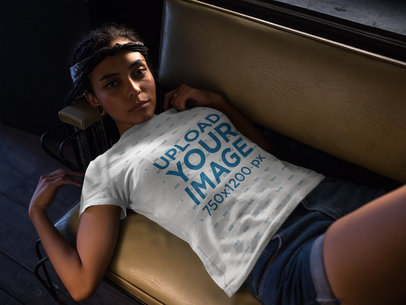Pretty Woman Wearing a T-Shirt Template While Lying Down on a Sofa