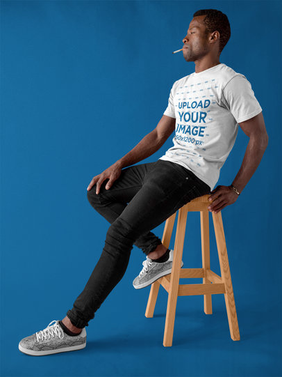 Dude Wearing a Round Neck Tee Mockup While Smoking at a Studio