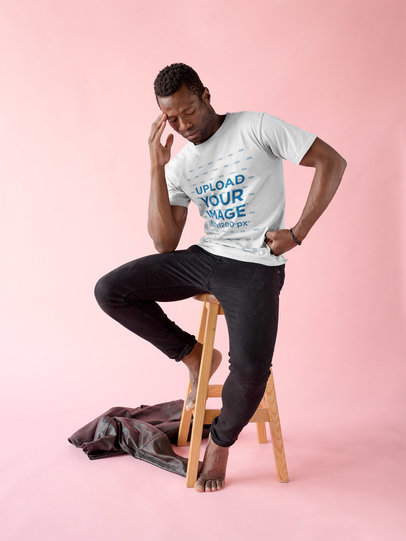 Black Man Wearing a Tshirt Mockup While Thinking on a Bench without Shoes a17158