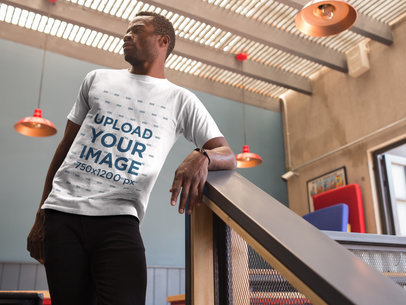 Mockup of a Man Hanging out at a Terrace While Wearing a Round Neck Tee Mockup