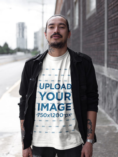 Tattooed Man Wearing a Tshirt Mockup While Walking on the Street