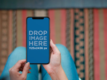 Woman Using an iPhone 11 Pro Mockup in her Living Room
