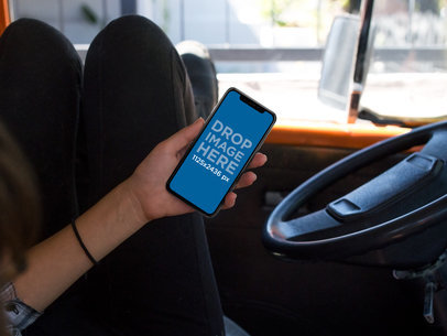 Girl Using an iPhone X Mockup While Inside a Van a17362