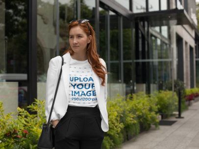 T-Shirt Mockup of a Fashion Woman Standing Near a Building Plants