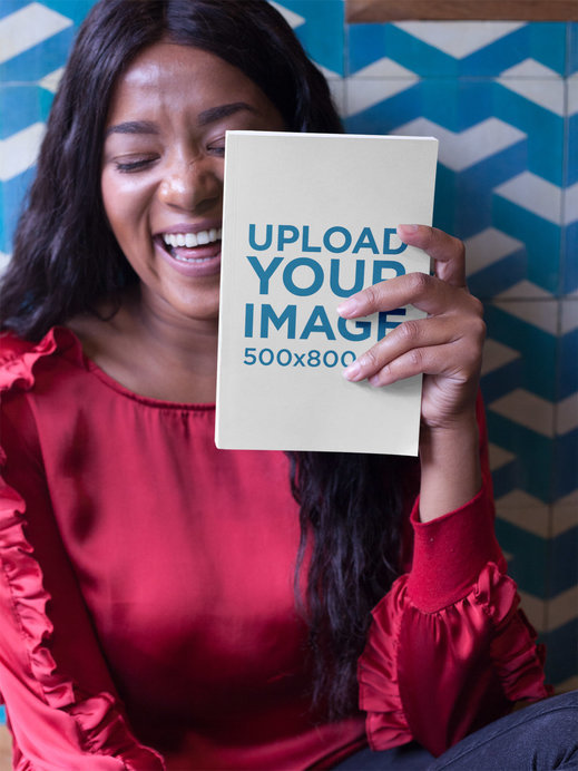 Happy Woman Holding a Book Mockup Near her Face