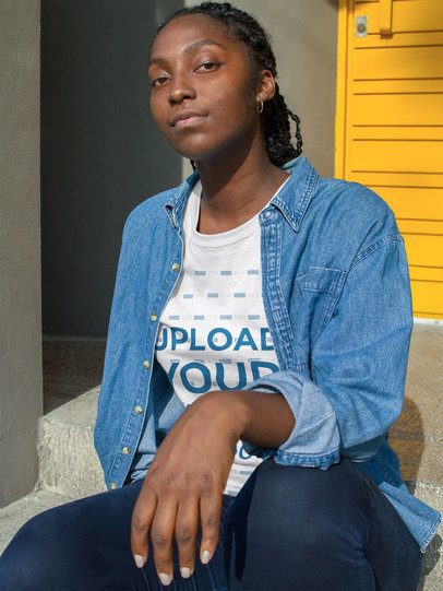 Mockup of a Woman with Attitude Wearing a T-Shirt While Near a Yellow Door 