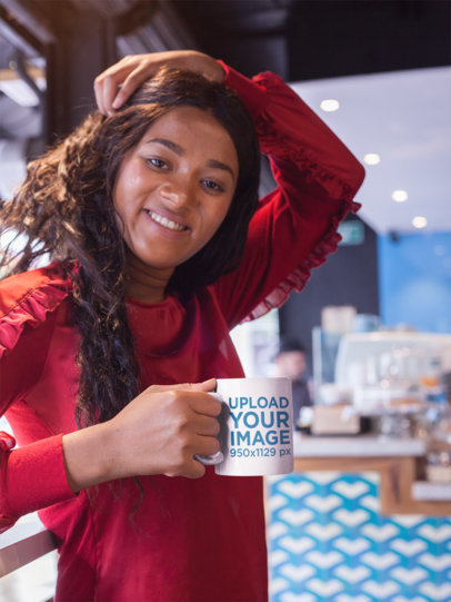 Mockup of a Smiling Beautiful Woman Holding a Coffee Cup While at a Cafe