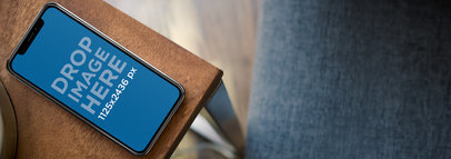 iPhone 11 Pro Mockup on the Corner of a Wooden Table