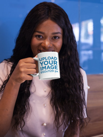 Mockup of a Woman Holding a Coffee Mug While Indoors 17339