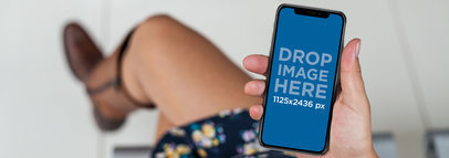 Woman in Cowboy Boots Using an iPhone 11 Pro Mockup