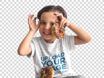 Transparent Mockup of a Happy Kid Playing with Donuts While Wearing a Round Neck T-Shirt