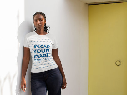 Mockup of a Woman wearing a T-shirt Near a Yellow Door 17314