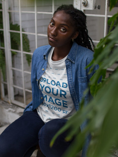 Woman Wearing a Round Neck Tee Mockup Near Plants
