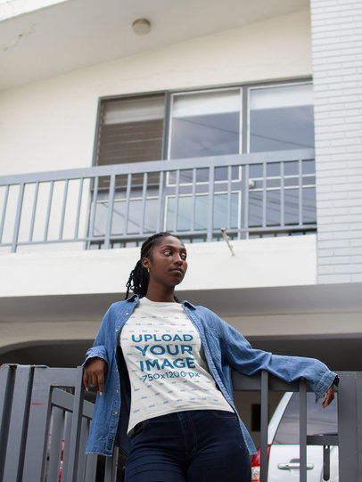 Mockup of a Woman Wearing a Round Neck T-shirt While Watching the Streets 