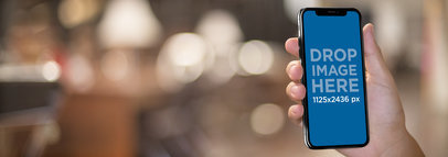 iPhone 11 Pro Mockup Being Held Against a Blurry Library