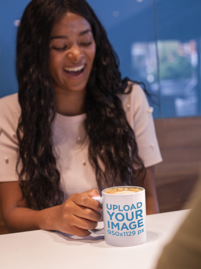 Happy Woman Holding a Coffee Cup Mockup in a Coffee Shop
