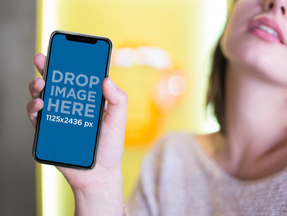 Mockup of a Woman Showing her iPhone 11 Pro