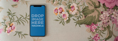 Mockup of an iPhone 11 Pro Lying on Top of a Vintage Table