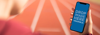 Woman in a Running Track Using an iPhone 11 Pro Mockup