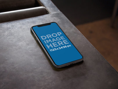 iPhone X Mockup Lying on a Metal Work Table a17481 