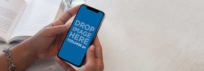 Girl Reading a Book While Wearing an iPhone X Mockup a17494