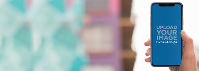 iPhone X Mockup Being Used at a Boutique a17482