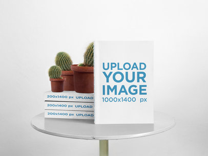 Mockup of Books Being Shown with Cactus on Them a17422