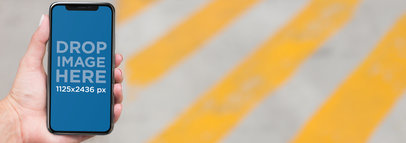 iPhone 11 Pro Mockup Used by a Woman Crossing the Street