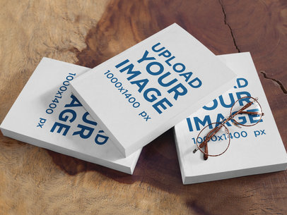 Mockup of Three Books and Reading Glasses on a Wooden Table a17420
