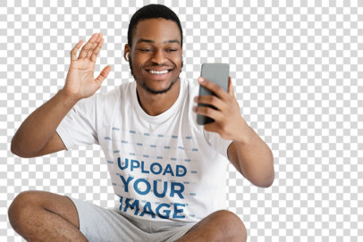 Transparent T-Shirt Mockup of a Man Doing a Video Call in His Bedroom