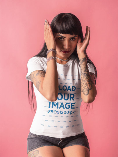 Tattooed Woman Wearing a Tshirt Mockup Covering her Face in the Studio