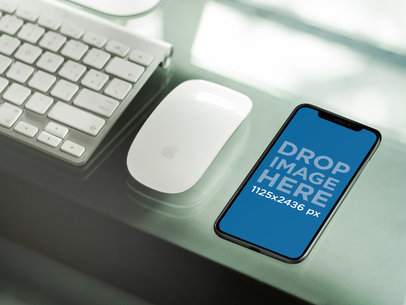 iPhone 11 Pro Mockup Lying Next to an Apple Desk at the Office