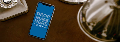 Mockup of an iPhone 11 Pro Lying on a Vintage Office Desk
