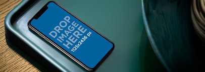Mockup of an iPhone 11 Pro on a Green Tray