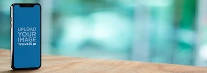 iPhone 11 Pro Mockup Standing on top of a Wooden Table