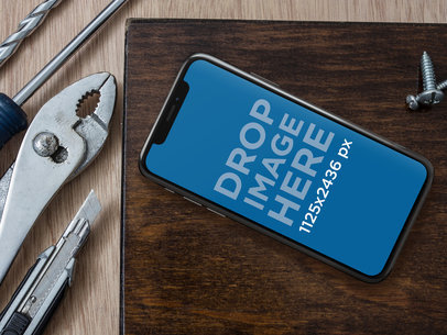 iPhone 11 Pro Mockup on a Workshop Table