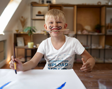 V-Neck T-Shirt Mockup of a Boy With a Mustache Painting