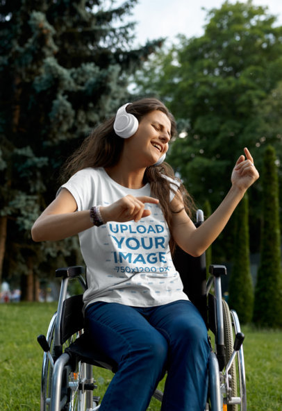 T-Shirt Mockup of a Woman Using a Wheelchair While Enjoying Some Music