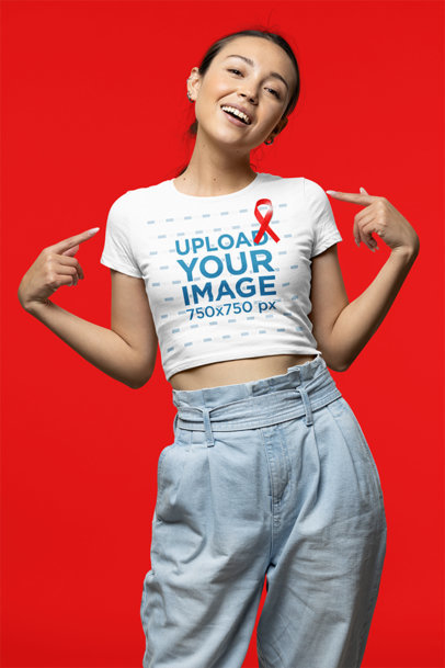 Mockup of a Woman Pointing at Her Crop Top While Supporting the Fight Against AIDS