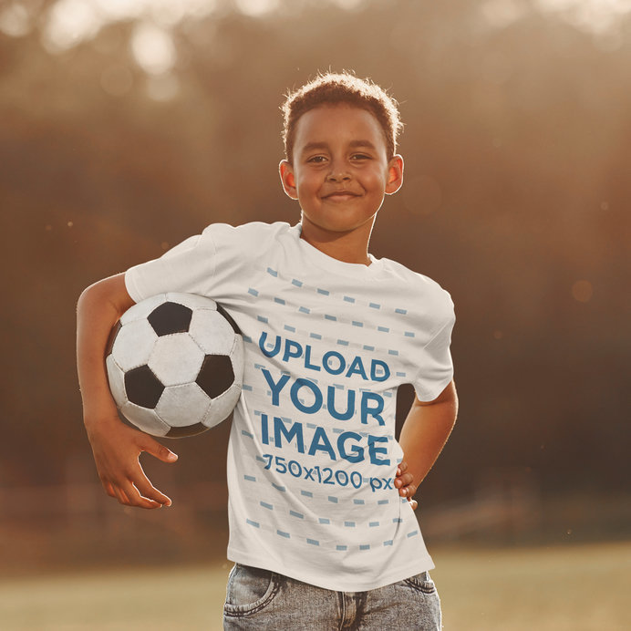 T-Shirt Mockup of a Teenager Holding a Soccer Ball at a Park