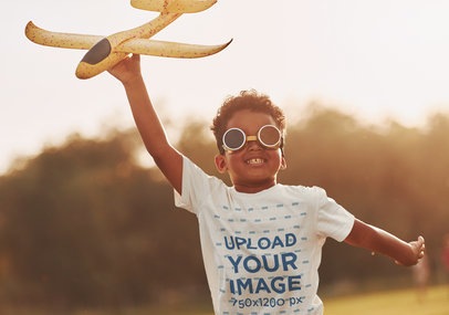 Round-Neck Tee Mockup of a Smiling Boy Flying a Toy Plane