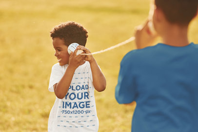 Basic T-Shirt Mockup Featuring a Happy Kid Having Fun