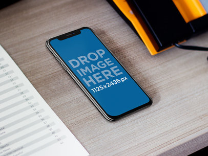 Space Gray iPhone 11 Pro Mockup at a Hotel Desk