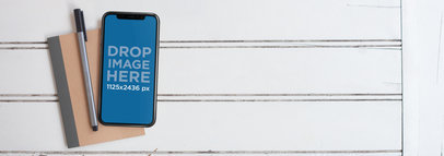 iPhone 11 Pro Mockup Lying on Top of a Notebook