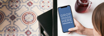 Woman Using an iPhone 11 Pro Mockup While Having a Drink